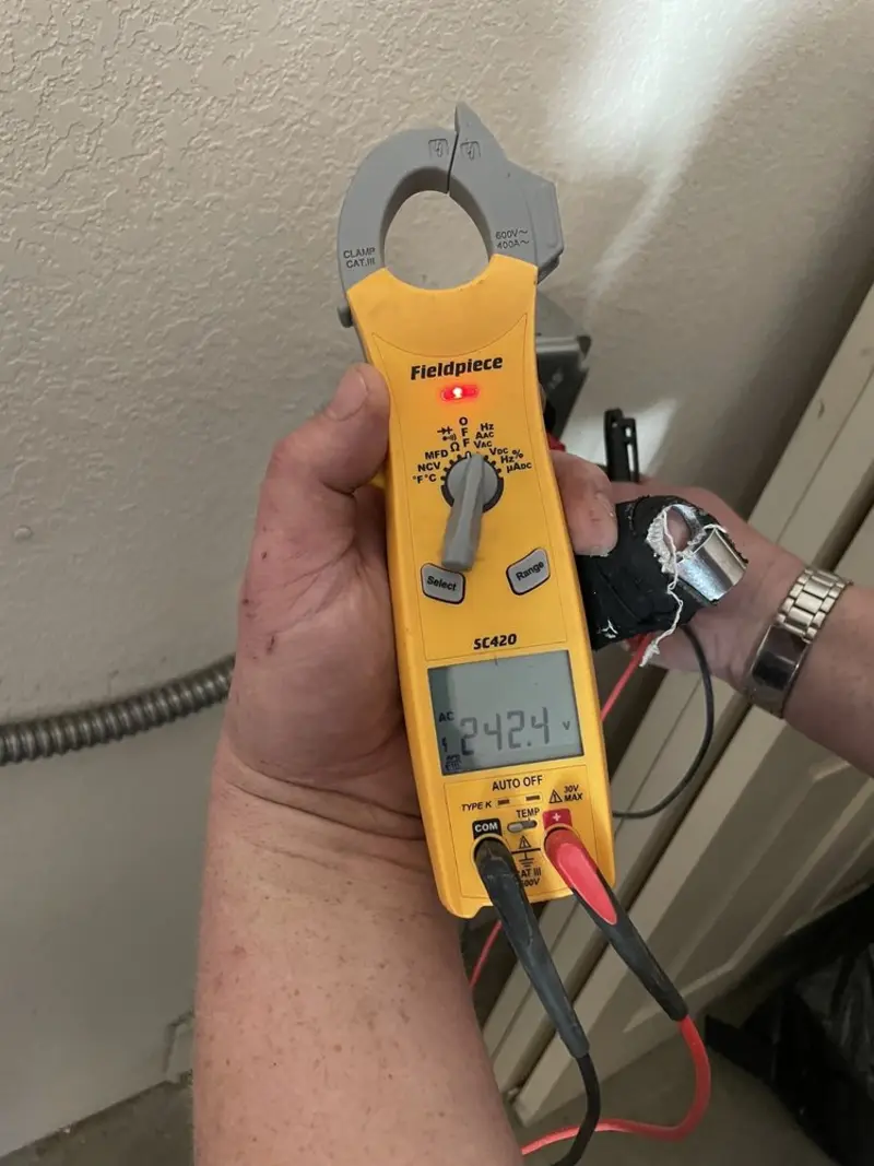 Voltage testing with clamp meter during Generator Installation in Oakland Park